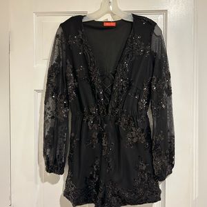 Long sleeve black sequin romper. Lace up front . Short pant.